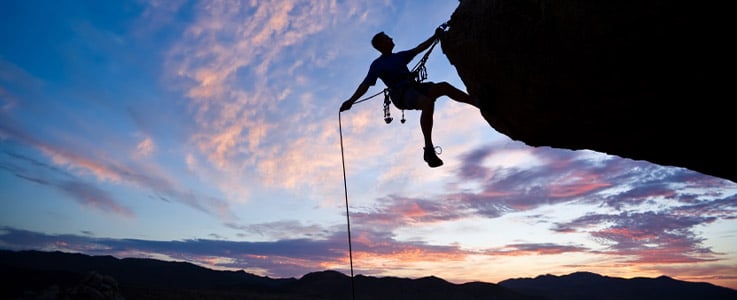 person hanging off cliff