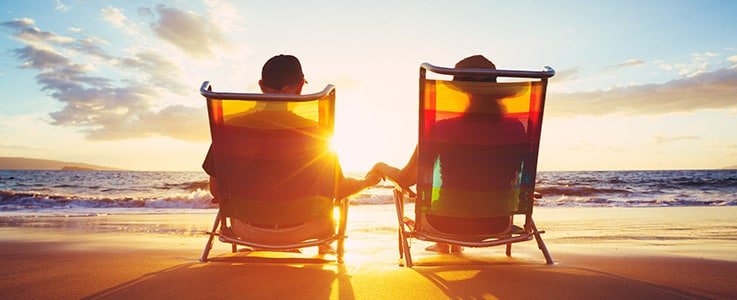 couple holding hands at beach sunset