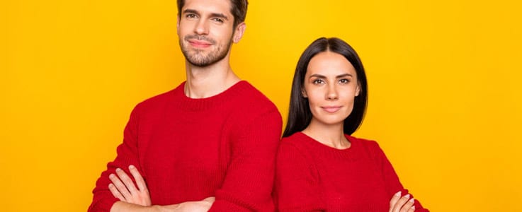 husband and wife in matching sweaters