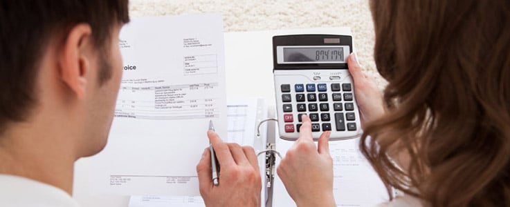 man and woman calculating finances