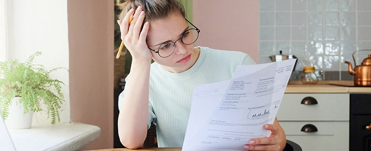 younger woman calculating papers