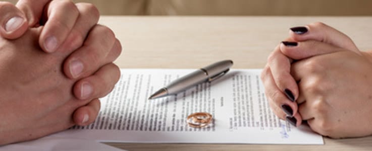 hands of husband and wife with divorce papers