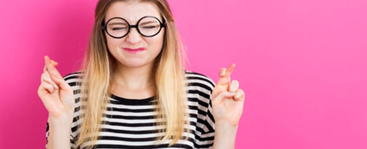 woman crossing fingers for good luck