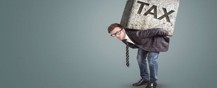 man carrying giant stone block reading tax