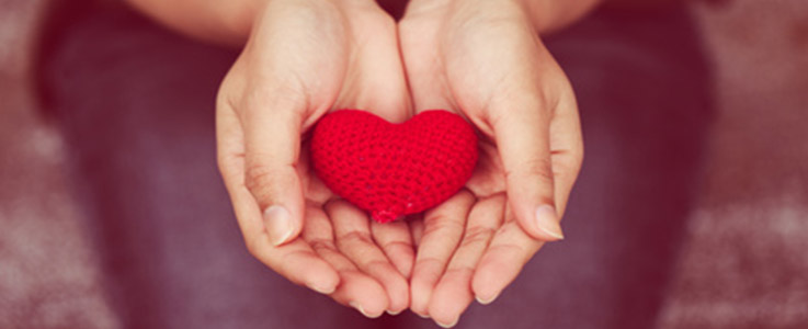 woman holding knitted heart