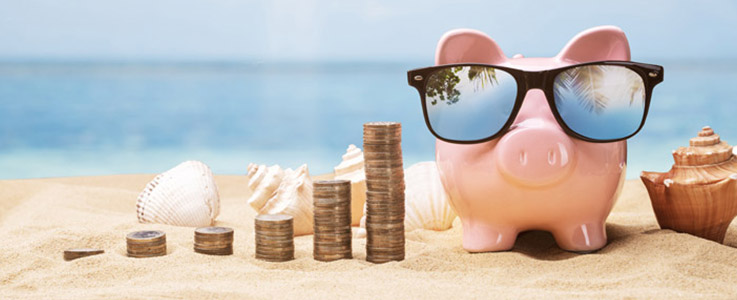 piggy bank at beach with coin stacks