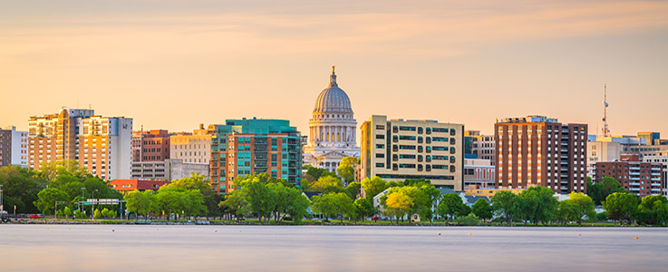 Madison, Wisconsin, USA downtown skyline at dusk on Lake Monona.